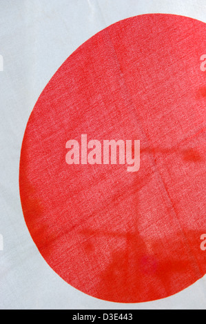 The Japanese flag is known as the hinomaru, or circle of the sun, or rising sun. A red disk against a white background. Stock Photo