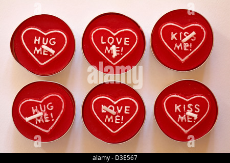 Valentine tealights tea lights candles - hug me love me kiss me isolated on white background Stock Photo