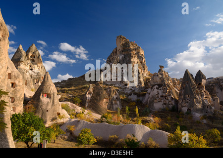 Ancient Uchisar Castle houses and tunnels at sunset carved out of volcanic tuff Cappadocia Turkey Stock Photo