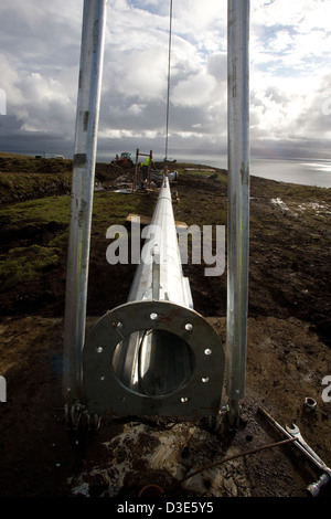 ISLAND OF EIGG, SCOTLAND - 30th OCTOBER 2007: Hinge bolts on the base of the first wind turbine tower are now in place so that the tower can be winched up into the vertical position. Stock Photo