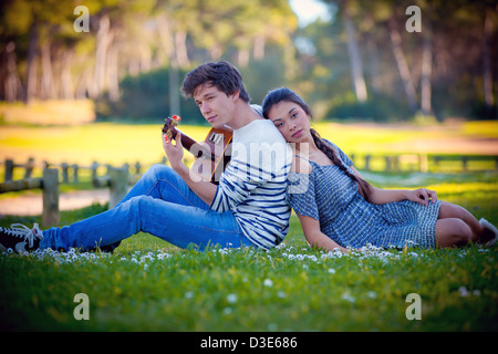 romantic couple in love playing guitar Stock Photo
