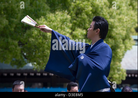 Man in kimono holding a folding fan performs a traditional dance called Hobu at the Meiji Jingu shrine in Tokyo. Stock Photo