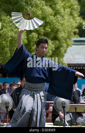 Man in kimono holding a folding fan performs a traditional dance called Hobu at the Meiji Jingu shrine in Tokyo. Stock Photo