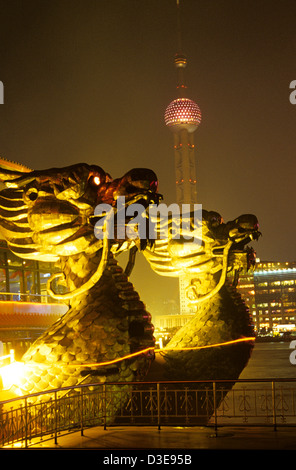 chinese dragons at night in shanghai with Pearl tower in the background