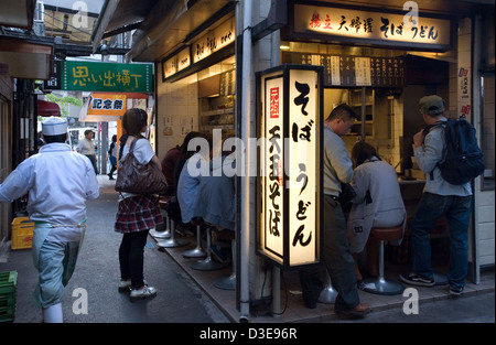 Unchanged since 1950's a narrow alley called Omoide Yokocho, or Memory Lane, in Shinjuku, Tokyo is packed with small restaurants Stock Photo