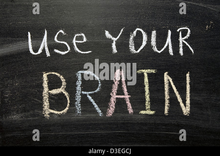 use your brain phrase handwritten on blackboard Stock Photo