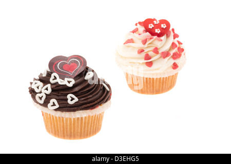 Two cup cakes decorated with a love and heart themed design - white background and a shallow depth of field Stock Photo