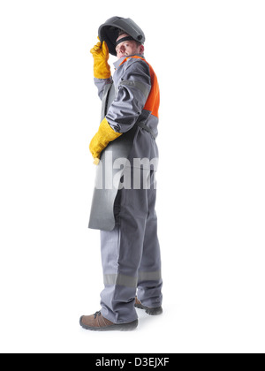 Portrait of welder wearing protective welding black leather apron and welding hood standing over white