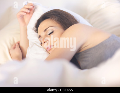 Beautiful asleep woman lying on her bed Stock Photo