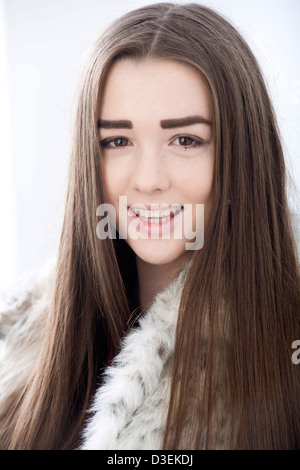 Fifteen year old girl with very long hair blowing about modeling in a ...