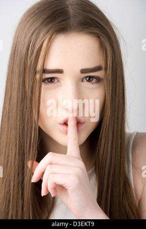 Teenage girl telling you to be quiet. Stock Photo