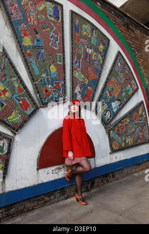 Lady In Red waiting for someone in Brick Lane Stock Photo