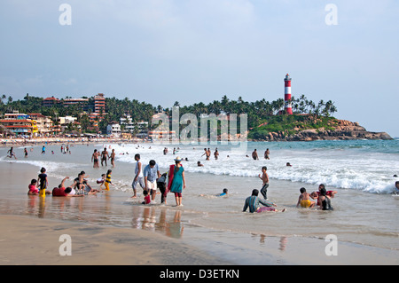 Kovalam Beach Kerala India Indian sea people water lighthouse pharos Stock Photo