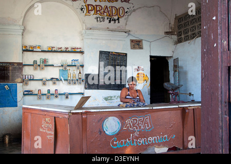 Shopkeeper behind counter of Cuban state shop in Cienfuegos, Cuba, Caribbean Stock Photo