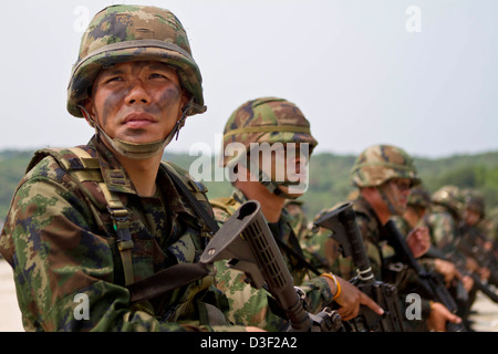 Royal Thai Marines assemble after coming ashore during a beach landing exercise during Cobra Gold 2013 February 15, 2013 in Hat Yao, Thailand. Cobra Gold is an annual event with the United States and Kingdom of Thailand to increase readiness in the Asia-Pacific region. Stock Photo