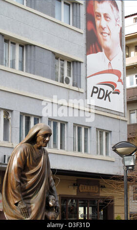 The statue of Mother Theresa, Albanian Nobel Peace Prize Laureate, stands a poster of Prime Minister of Kosovo hanging on the facade of a building in Pristina, Kosovo, 13 February 2013. Countless attempts have be undertaken to stop the continued conflict in Kosovo. The UN, the OSCE, the USA, the EU and NATO are having a difficult time finding a solution to this flash point region. Photo: Thomas Brey Stock Photo