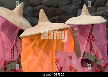 Three maidens wearing traditional kimono, wide-rimmed straw hats and silky veils during the Odawara Hojo Godai Matsuri festival Stock Photo