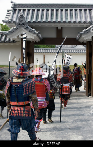 Clan of samurai warriors wearing traditional armor go through gate at Odawara Castle during Odawara Hojo Godai Matsuri festival Stock Photo