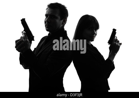 one  man detective secret agent criminal with gun in silhouette studio isolated on white background Stock Photo