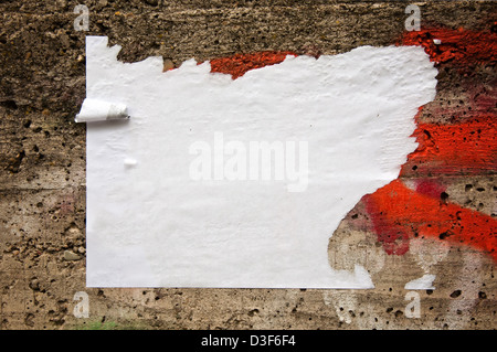 Blank torn paper poster on an old brick wall Stock Photo