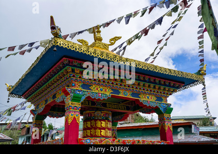 Large Buddhist prayer wheel in colorful enclosure with prayer flags, Tawang, Arunachal Pradesh, India. Stock Photo