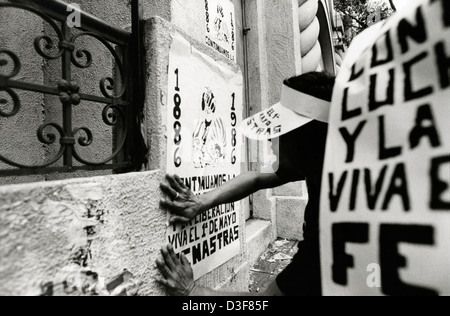 SAN SALVADOR, EL SALVADOR, May 1986: Fly-posting during the May Day march in San Salvador. Stock Photo