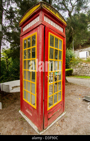 View of a cool red and yellow phone booth. Stock Photo