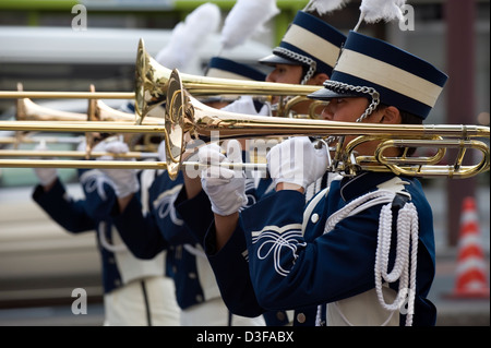 Trombone players in full costume performing in a Western-style marching band during a festival in Japan. Stock Photo