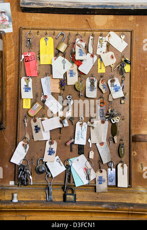 Keys and locks hanging on the wall behind the front desk at the Idaho Hotel in the historic mining town of Silver City, Idaho. Stock Photo