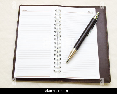 Opened pocket notebook and ballpen on the right Stock Photo