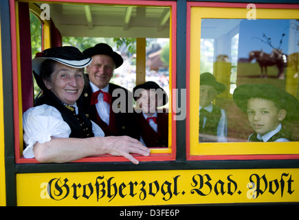 St. Märgen, Germany, family sitting in costumes in a carriage on Rosstag Stock Photo