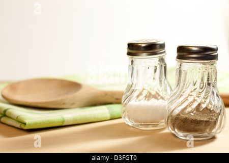Salt and pepper in the kitchen on wooden board Stock Photo