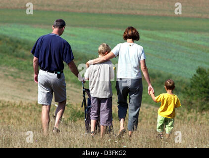 (dpa files) - A family goes for a walk through fields in Kelkheim, Germany, 30 August 2003. The German government wants to give also older couples the possibility to adopt children in the future. Renate Schmidt, German Minister for Family, Seniors, Women and Youth, told the newspaper 'Berliner Zeitung' (issue of 13 December 2004) that the guidelines for adopting will be adjusted to Stock Photo