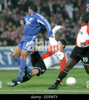 (dpa) - Rotterdam player Karim Saidi (bottom, C) slides into Schalke striker Ailton (L) during the UEFA Cup match between Dutch club Feyenoord Rotterdam and German side FC Schalke 04 at De Kuip Stadium in Rotterdam, the Netherlands, 1 December 2004. Rotterdam won the match 2-1 but both clubs managed to qualify for the last 32 of the UEFA Cup. Stock Photo