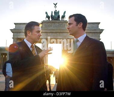 (dpa) - Spanish Crown Prince Felipe (R) chats with Berlin's mayor Klaus Wowereit during his four day visit to the German capital in front of the Brandenburg Gate with the sun shining through the gate in Berlin, 18 March 2003.  During his visit to Germany Felipe will, among many other duties, also inaugurate the Spanish culture institute Cervantes in Berlin. Stock Photo