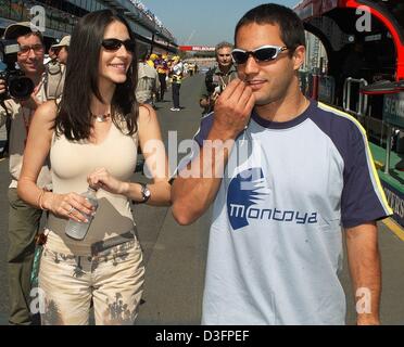 (dpa) - Colombian formula one driver Pablo Montoya (BMW-Williams) takes his wife Conny out for a stroll at the racetrack in Melbourne, Australia, 6 March 2003. The formula one season 2003 will open this weekend in Melbourne on 9 March 2003. Stock Photo