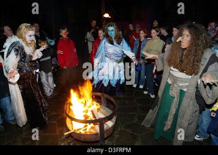 (dpa) - Women dressed up as witches dance around a fire celebrating Walpurgis Night in Brodenbach, western Germany, 1 May 2003. Walpurgis Night is an old pagan festival, which borrowed its name from Saint Walburga whose feast occurs on May Day. On this night witches are believed to ride on broomsticks and he-goats to places of old pagan sacrifices in the Harz Mountains, especially  Stock Photo