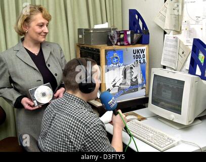 (dpa) - Marion-Annett Retkowski, head of the editorial office, stands next to the 19-year-old prisoner Nico in the studio of Germany's first prison radio, in Hameln, Germany, 26 February 2003. Nico has been working in this radio project for three quarters of a year. The radio gives listeners an idea of what happens behind the walls of the juvenile prison. For two years prisoners ha Stock Photo