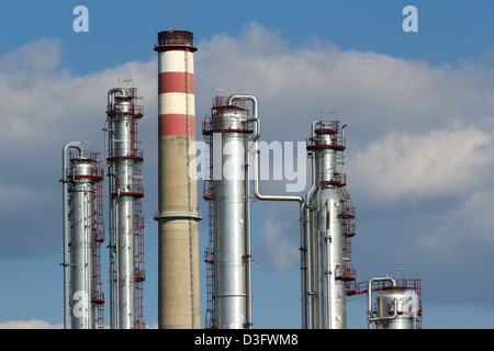 silver steel and concrete chimney of oil refinery Stock Photo