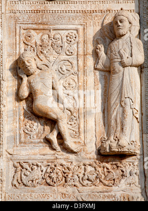 VERONA - JANUARY 27: Relief of creation of Adam from romanesque Basilica San Zeno. Stock Photo