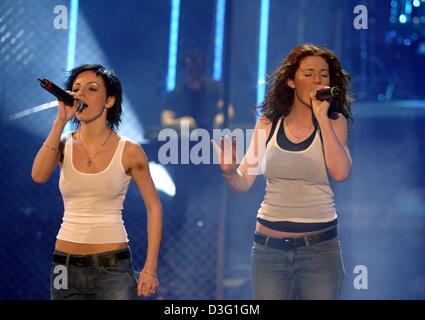 (dpa) - Julia Volkova and Lena Katina of the Russian girl duo T.A.T.U. perform during the popular TV show 'Wetten dass...?' (bet that...?), in Lucerne, Switzerland, 22 March 2003. The liveshow broadcast by the German TV station ZDF was watched by 13.8 million people, which is a market share of 44 per cent, although the show was subject to be cancelled at the last minute due to the  Stock Photo