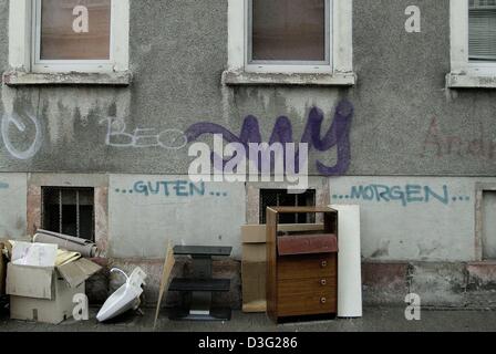 (dpa) - The words 'Guten Morgen' (good morning) are sprayed underneath the empty windows and litter stands in front of a rundown house in Frankfurt Oder, eastern Germany, 7 March 2003. Stock Photo