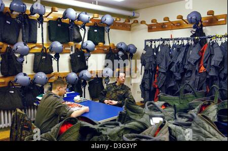 (dpa) - Two pilots sit in the outfit and equipment cabin at the air base of the fighter squadron 74 'Moelders' in Neuburg, Germany, 5 February 2003. The fighter squadron was awarded the name Moelders on 22 November 1973 which was the 32nd anniversary of the death of Colonel Werner Moelders. The squadron 74 is one of four more squadrons 'Richthofen', 'Boelcke', 'Immelmann' and 'Stei Stock Photo