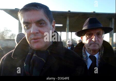 (dpa) - Romani Rose, Chairman of the Central Consistory of Sinti and Roma in Germany, and Walter Stanowski Winter, a survivor of the Nazi concentration camp in Auschwitz, walk past the crematory at the former Nazi concentration camp Sachsenhausen in Oranienburg, Germany, 18 December 2003. The day marks the 61st anniversary of the Auschwitz decree, which sealed the destiny of thousa Stock Photo