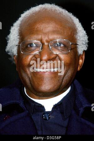 (dpa) - Desmond Tutu, former Archbishop of South Africa and Nobel Peace Prize Laureate, smiles during his visit to the soccer globe at the Opernplatz (opera square) in Frankfurt Main, Germany 4 December 2003. Tutu attended as a guest of honour the drawing of the preliminary round for the 2006 FIFA Soccer World Cup in Germany. Stock Photo