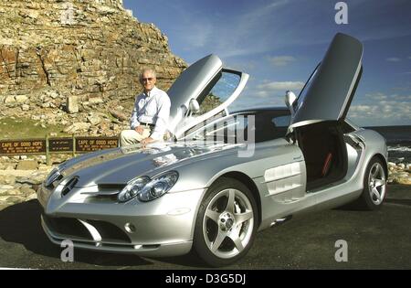 (dpa) - Juergen Hubbert, member of the Board of Management of the DaimlerChrysler group and responsible for the Mercedes Car Group division, presents the new sportscar, a Mercedes-Benz SLR McLaren, in Cape Town, South Africa, 28 November 2003. The car, with a maximum speed of 334 kmph and 626 hp, is manufactured at the McLaren facilities in Woking, England. The car was limited to 3 Stock Photo