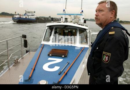 (dpa) - Officer Martin Schubert Huebner stands on a police boat WSP2 of the river police in Duesseldorf, Germany, 1 October 2003. Stock Photo