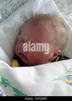 (dpa) - The infant which was found abandoned on 11 November is sleeping in the hospital in Itzehoe, Germany, 12 November 2003. The one to three days old boy was laid down at the entrance of a one-family house, then the bell rang, the police reported. The 65-year-old tenant and her daughter then discovered the baby which was wrapped in a pullover, and called the police. The identity Stock Photo