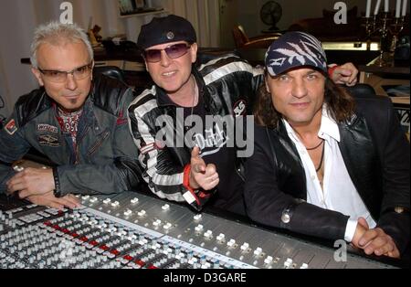 (dpa) - The core members of the German rock band 'Scorpions', (from L:) Rudolf Schenker (guitar), Klaus Meine (singer) and Matthias Jabs (guitar) pose in a sound studio in Hanover, Germany, 15 April 2004. The Scorpions are getting back to their roots and their original fans with their laterst album. The CD is entitled 'Unbreakable' and will be released on 3 May. The Scorpions came  Stock Photo