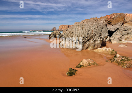 Portugal, Algarve: Rock formations and  ebb tide at beach Praia do Tonel with Cape St. Vincent in the background Stock Photo